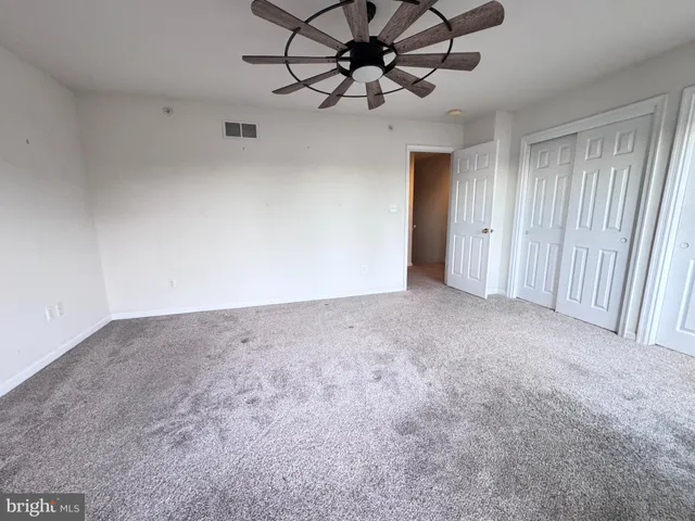 a view of a livingroom with a ceiling fan and window