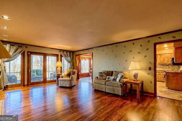 a kitchen with stainless steel appliances kitchen island granite countertop a table and chairs in it