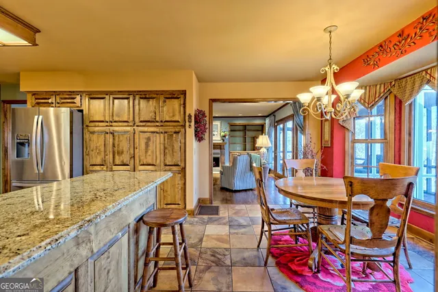 a view of a dining room with furniture chandelier and wooden floor