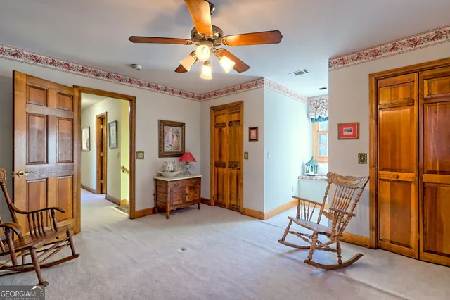 a bedroom with furniture and a large window