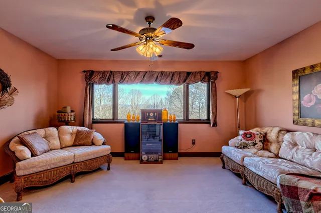 a bedroom with a bed ceiling fan and a window