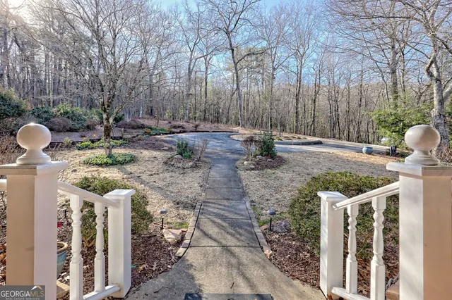 a view of a hallway with wooden floor and furniture