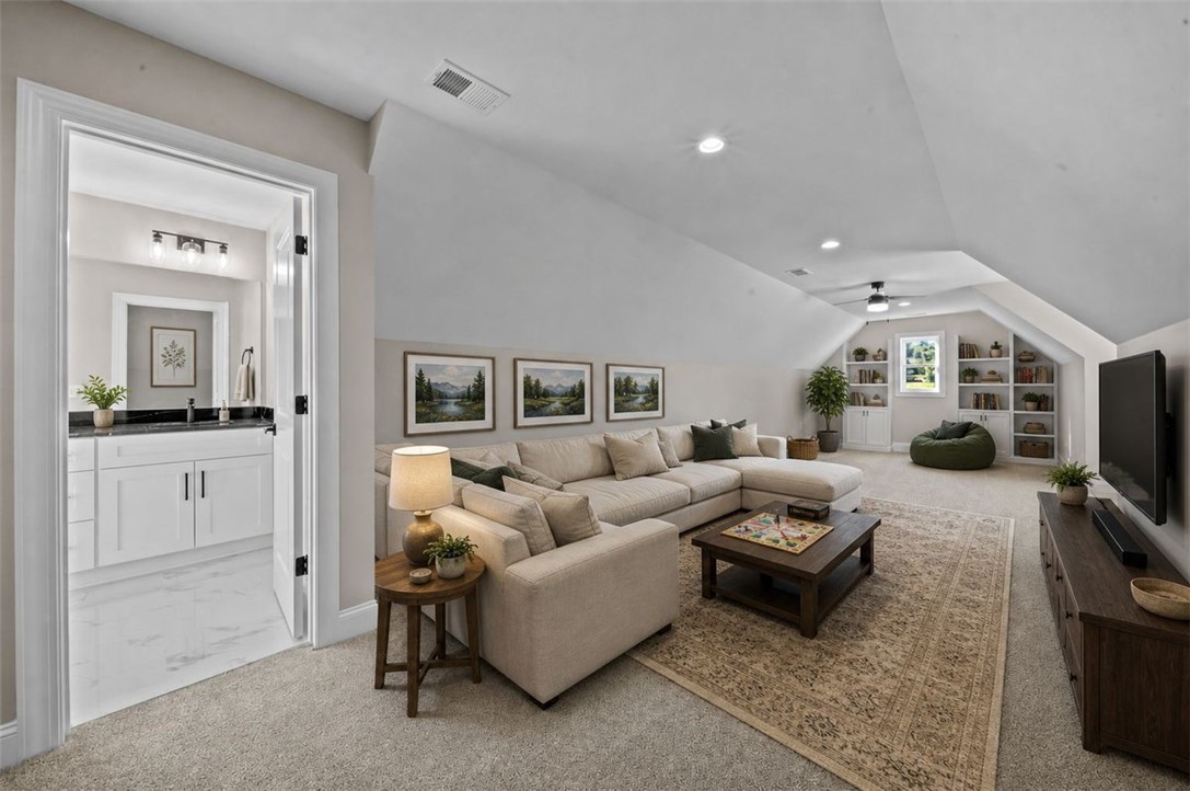 105 Bree Drive Anderson, SC 29621 - Photo 2 of 48 A spacious recreation room, bathed in natural light, offers built-in shelving for extensive storage and display.