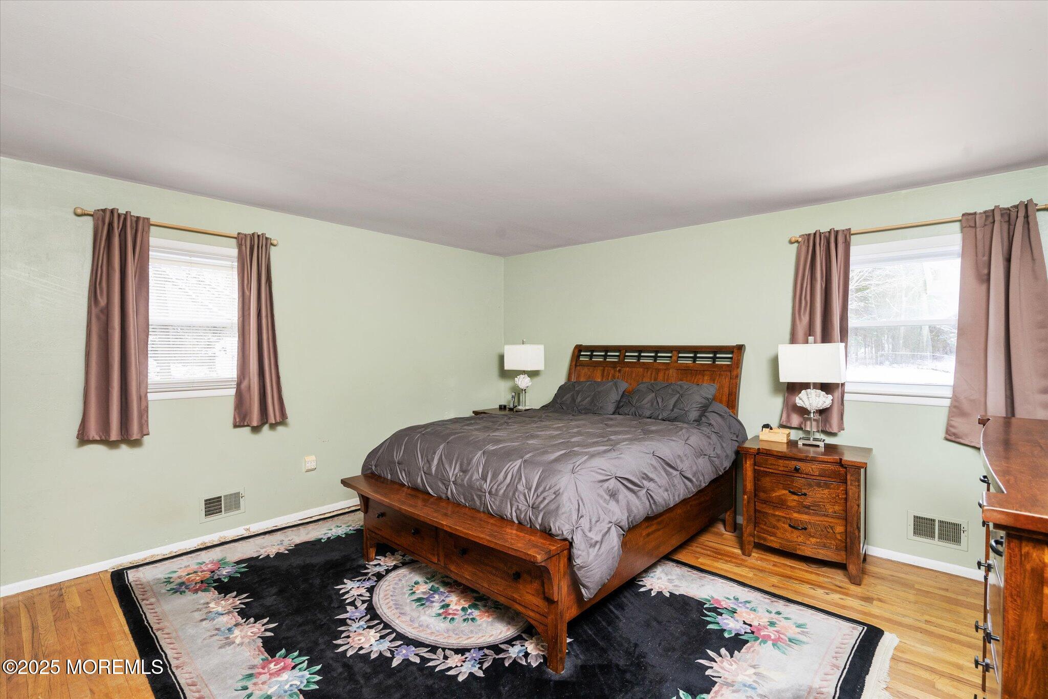 90 Valley Road Jackson, NJ 08527 - Photo 18 of 44 a bedroom with a bed and wooden floor