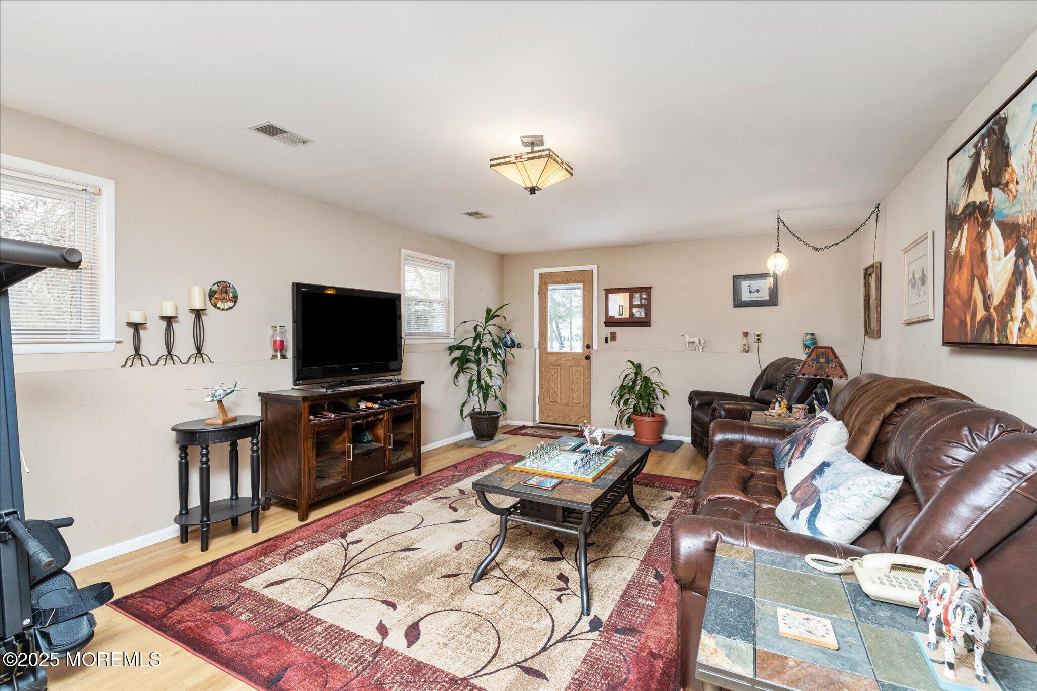90 Valley Road Jackson, NJ 08527 - Photo 28 of 44 a living room with furniture a flat screen tv and a dining table