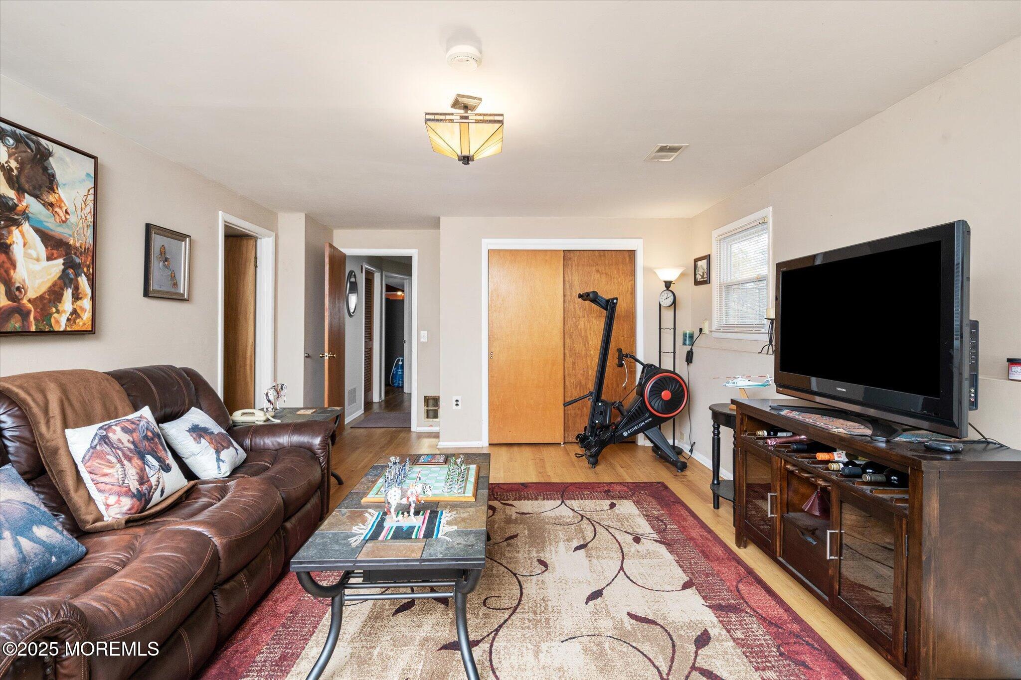 90 Valley Road Jackson, NJ 08527 - Photo 29 of 44 a living room with furniture and a flat screen tv