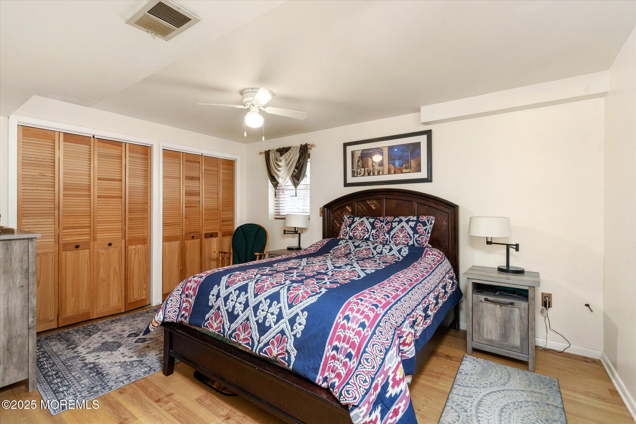 90 Valley Road Jackson, NJ 08527 - Photo 30 of 44 a bedroom with a large bed and a chandelier