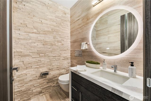 a bathroom with a sink a toilet and a mirror