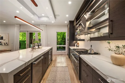 a kitchen with stainless steel appliances granite countertop a sink stove and cabinets