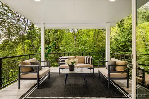 a outdoor living room with furniture and a large window