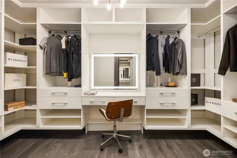 a view of walk in closet with clothes and shoes