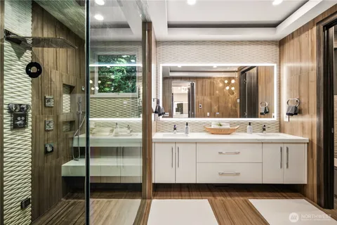 a bathroom with a double vanity sink and mirror