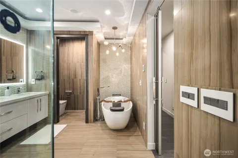 a bathroom with a granite countertop sink a toilet and a mirror