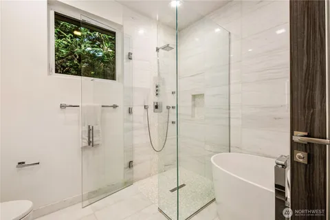 a bathroom with a bathtub and shower