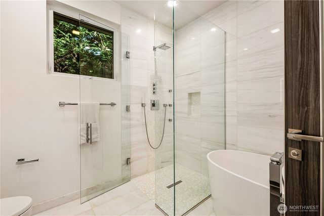 a bathroom with a bathtub and shower