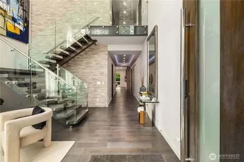 a hallway with a couch and a flat screen tv