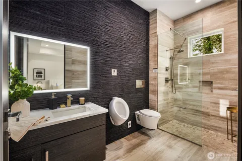 a bathroom with a toilet sink and mirror