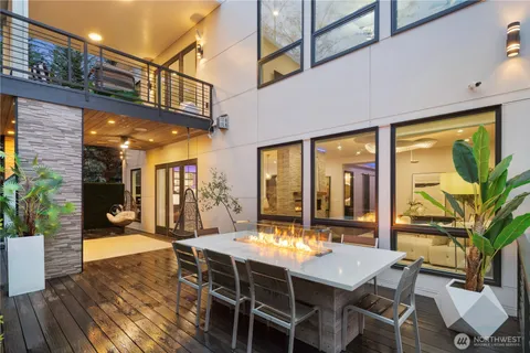 a view of a patio with a table and chairs and potted plants