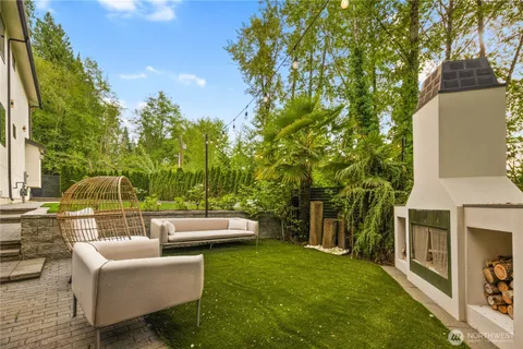 a view of a patio with couches table and chairs and potted plants