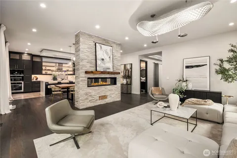 a living room with furniture and kitchen view