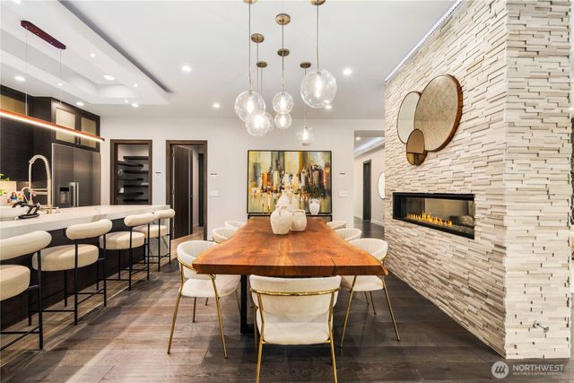 a view of a dining room with furniture and a fireplace