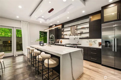 a kitchen with stainless steel appliances kitchen island granite countertop a sink and cabinets