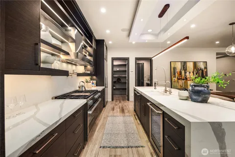 a kitchen with stainless steel appliances granite countertop a sink and stove