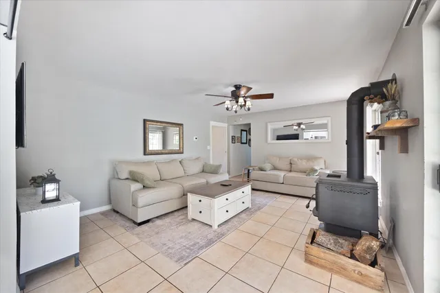 a kitchen with white cabinets appliances a sink and a window