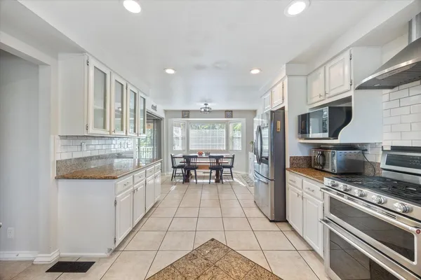 a bedroom with a bed couch and a ceiling fan
