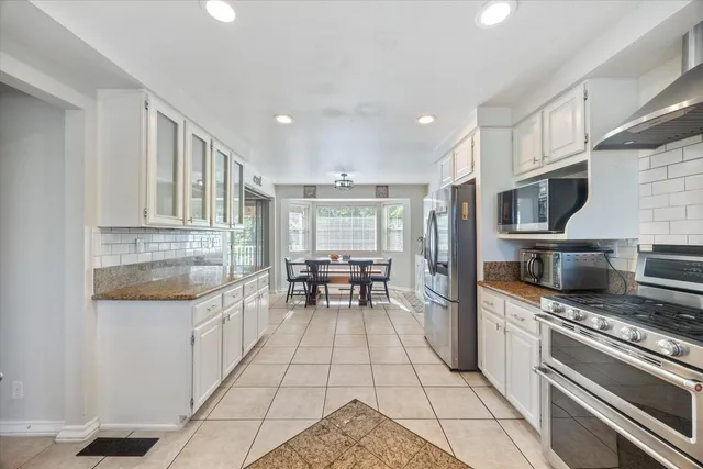 a bedroom with a bed couch and a ceiling fan