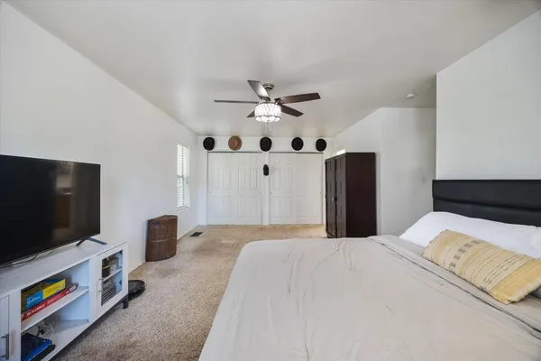 a bathroom with a granite countertop double vanity sink a mirror and a shower