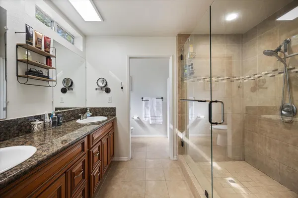 a bathroom with a glass shower door