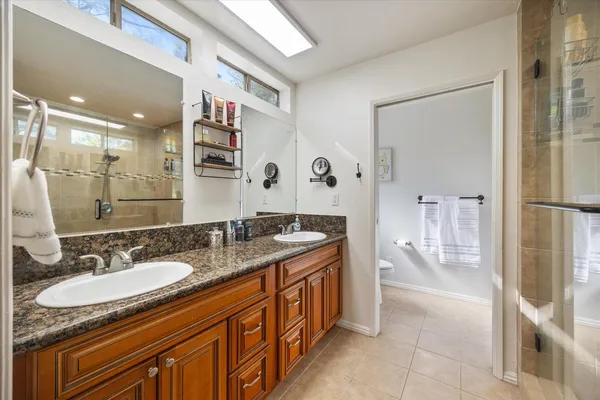 a white toilet sitting next to a bathroom sink