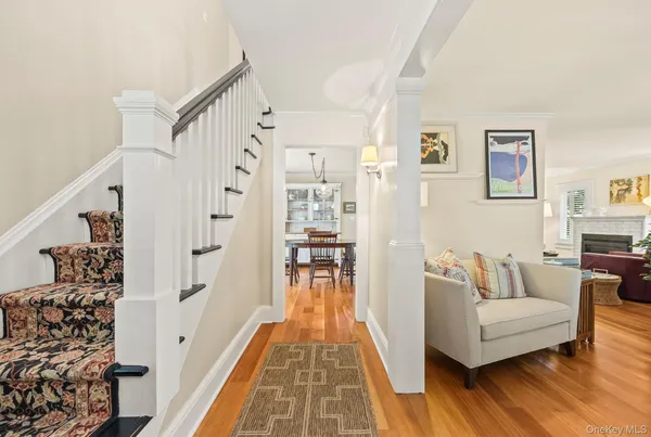 a living room with fireplace furniture and a wooden floor