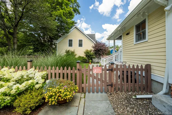 a view of a house with wooden fence