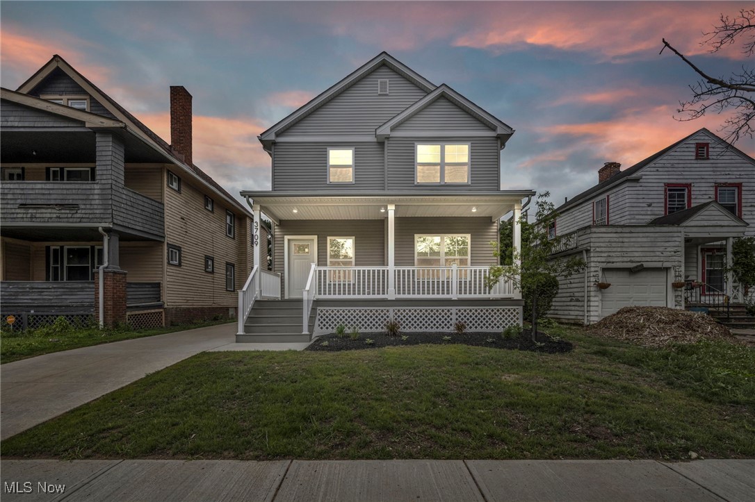 3709 Sudbury Road Cleveland, OH 44120 - Photo 2 of 29 View of front facade featuring a garage, a porch, and a lawn