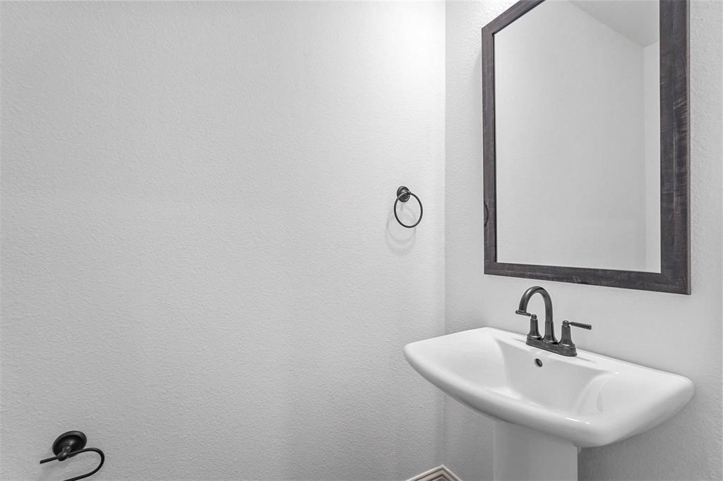 2640 Bluejack Road McKinney, TX 75071 - Photo 18 of 18 a bathroom with a sink and mirror