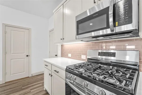 a kitchen with a stove and a microwave