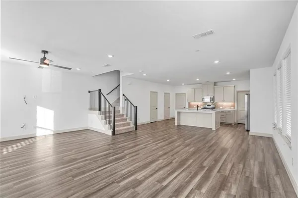 a view of a kitchen with wooden floor and a sink