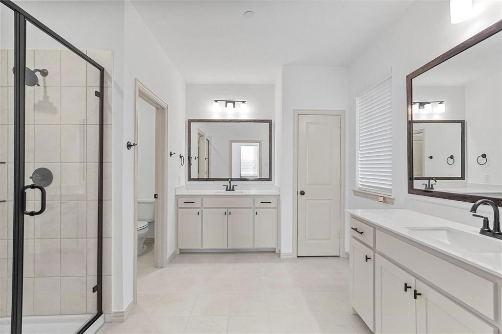 2640 Bluejack Road McKinney, TX 75071 - Photo 8 of 18 a spacious bathroom with a double vanity sink mirror and shower