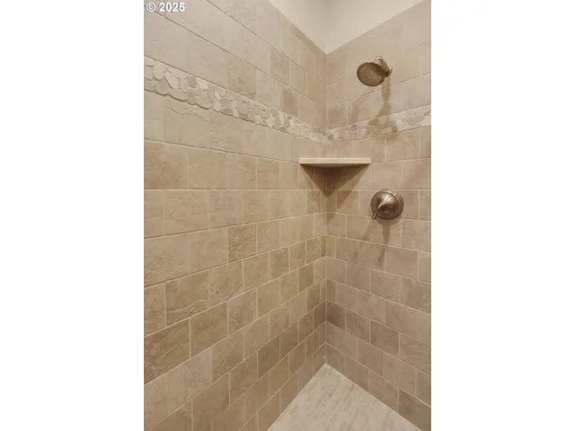 a living room with furniture a flat screen tv and a window