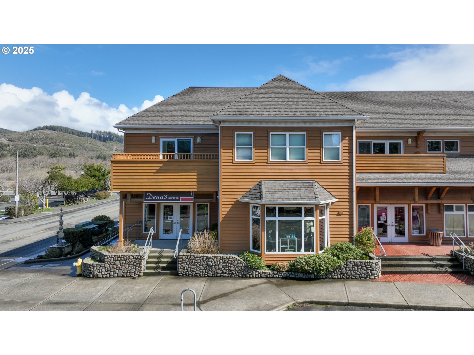 123 South Hemlock Street, Unit 201 Cannon Beach, OR 97110 - Photo 6 of 48 a front view of a house with a yard