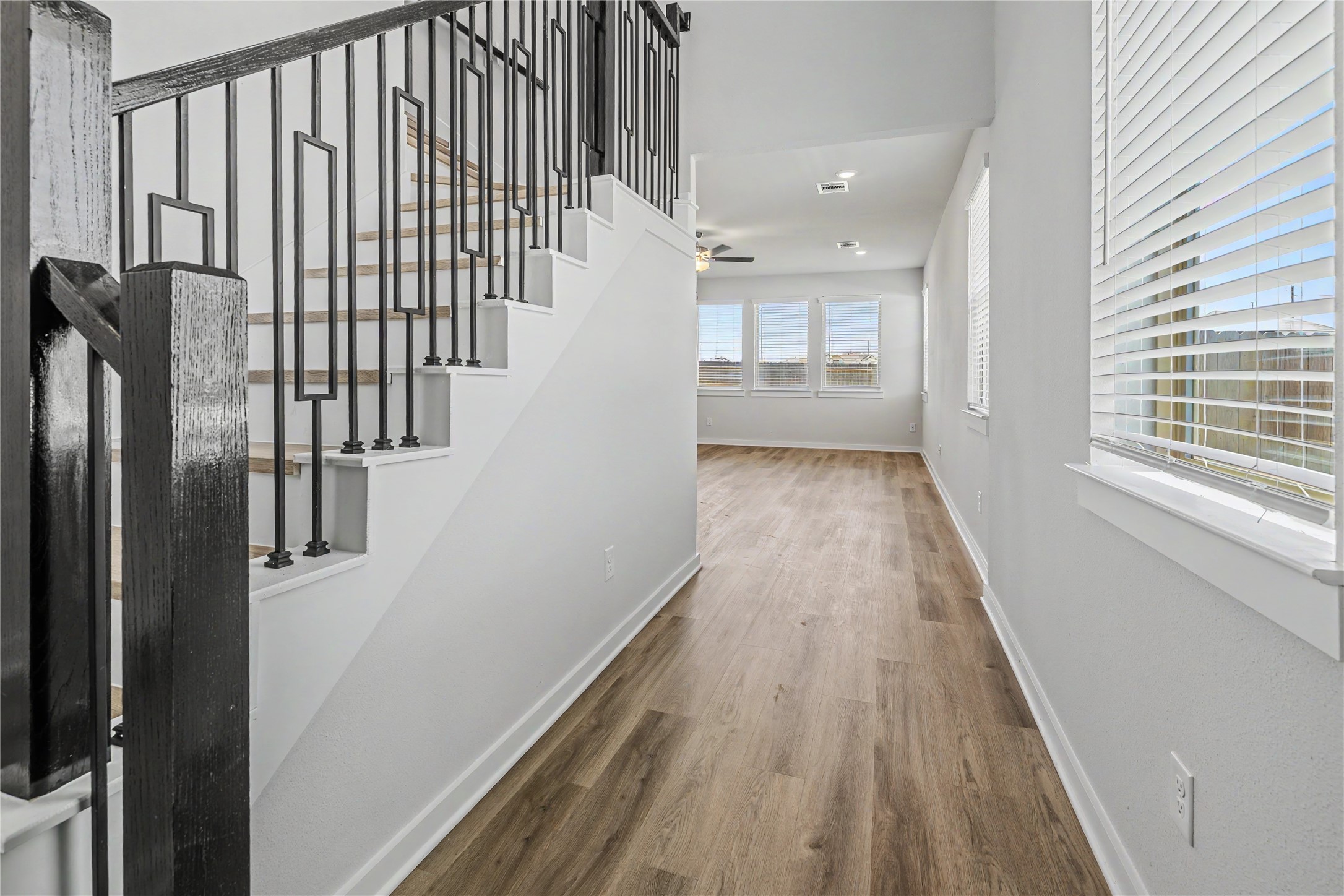 6427 Bolinas Court Rosharon, TX 77583 - Photo 6 of 49 a view of a hallway with wooden floor and staircase