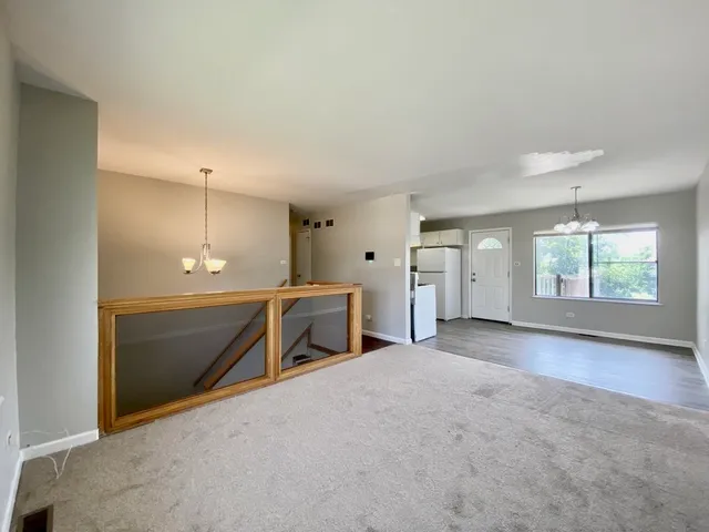 an empty room with a empty space and windows