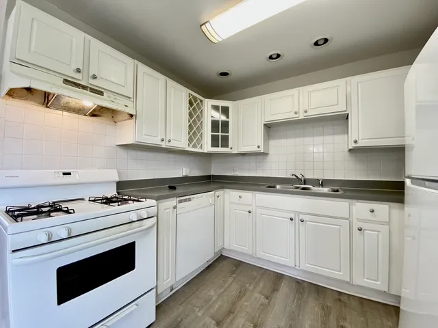 a kitchen with stainless steel appliances granite countertop a sink and cabinets