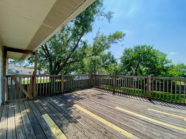 a balcony with wooden floor