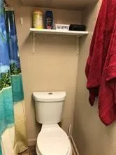 a white toilet sitting next to a white sink