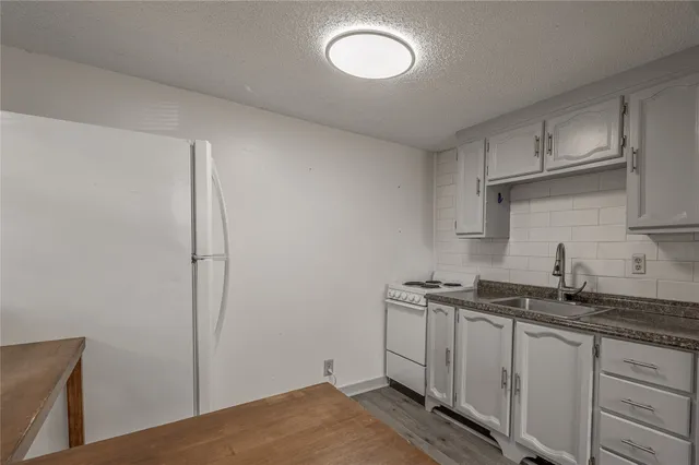 a kitchen with a refrigerator and cabinets