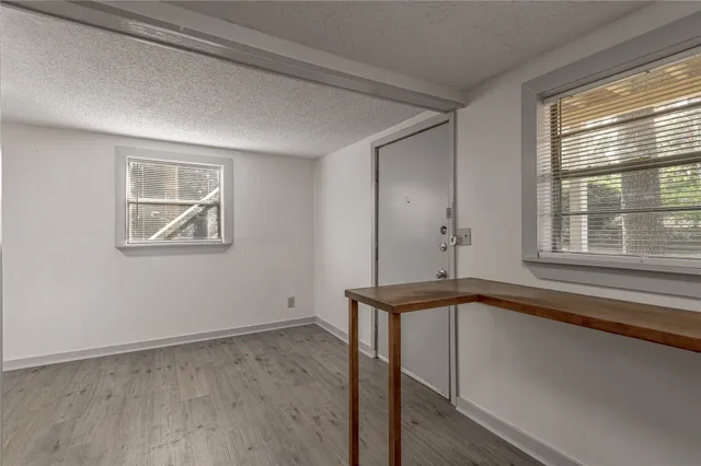 a kitchen with granite countertop a sink a stove and cabinets