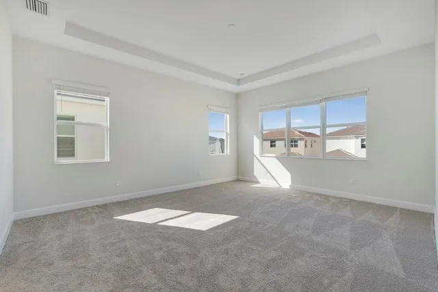 a view of empty room with a kitchen